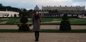 Carole poses with the stately Palais Versailles behind her.